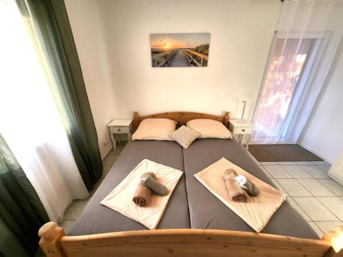 a bedroom with a bed with slippers on it at Apartments Pitve in Jelsa