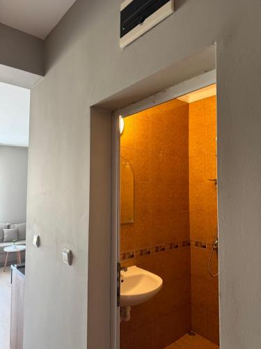 a bathroom with a sink and a toilet and a mirror at Студио Мая in Sunny Beach