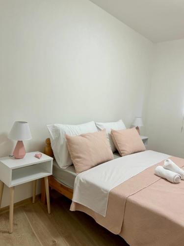a bedroom with two beds and a table with a lamp at Jelena in Jajce