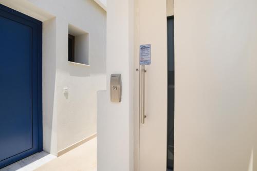 a door in a building with a sign on it at Mylos Luxury Escape Villa in Faliraki