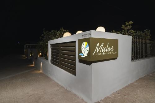 a sign on the side of a wall at night at Mylos Luxury Escape Villa in Faliraki