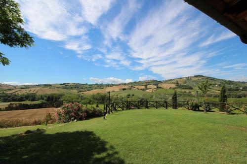 a view of a field with a fence and mountains at Agriturismo L'Arcadia in Citta' Sant'Angelo