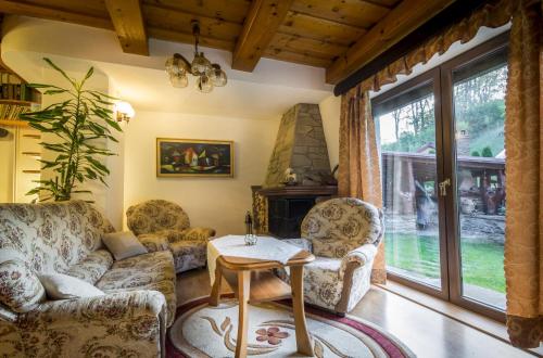a living room with two couches and a table at Penzion U Sovy in Dolný Kubín