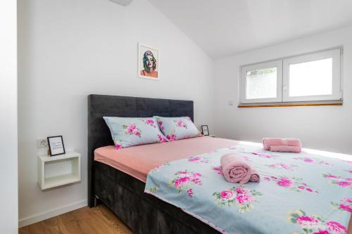 a bedroom with a bed with a stuffed animal on it at Villa Nika in Konjevrate