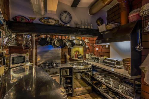 a kitchen with many pots and pans on the wall at Penzion U Sovy in Dolný Kubín