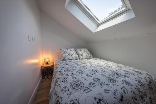 une chambre avec un lit et une fenêtre dans l'établissement Le Ru De Biche - 20min Disney - SPA du 01 05 au 01 11 - paisible, à Guérard