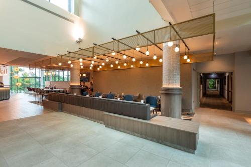 a lobby with a waiting area with chairs and lights at Crowne Plaza Birmingham NEC by IHG in Bickenhill
