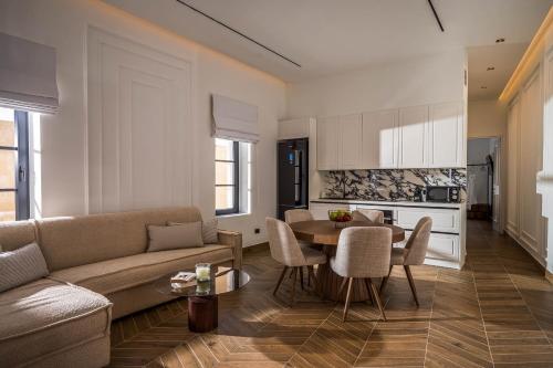 a living room with a couch and a table at Montre Fine Living in Agios Nikolaos