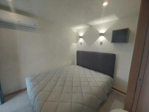a bedroom with a bed with lights on the wall at Cantinho de Trevoeiros - Casa Duarte in Arcos de Valdevez