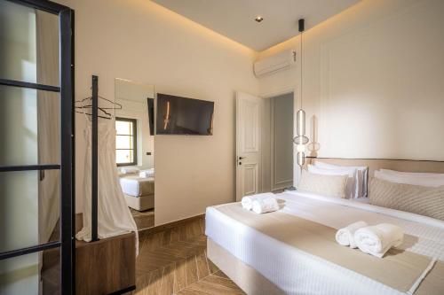 a hotel room with a bed with towels on it at Montre Fine Living in Agios Nikolaos
