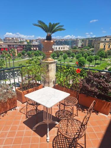a white table and chairs on a patio with a view at La Casa di Mary in Ercolano