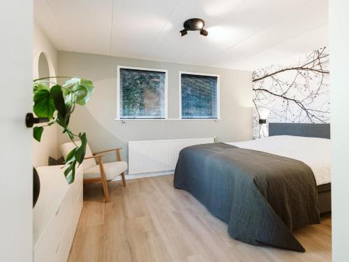 a bedroom with a bed and a plant at Prinsenhof 43 - Ouddorp in Ouddorp