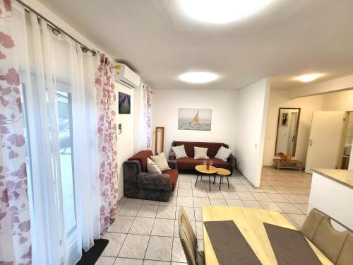 a living room with a couch and a table at Apartments Pitve in Jelsa