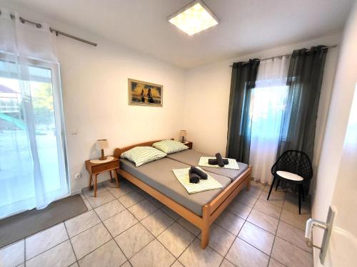 a bedroom with a bed and a large window at Apartments Pitve in Jelsa