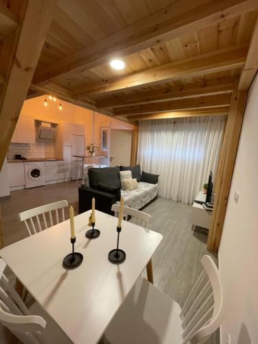 a kitchen and a living room with a table and chairs at Apartamento de la Luz in Tarifa