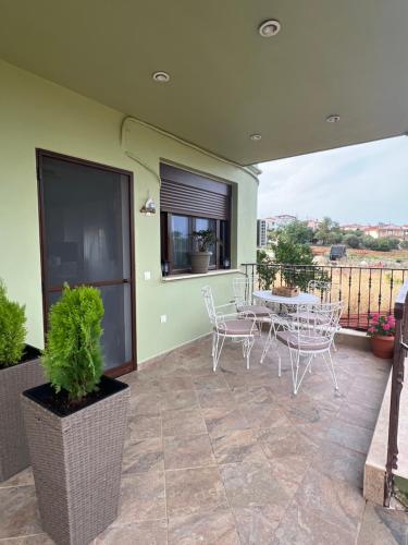 a patio with a table and chairs on a balcony at Ioannis Villa in Nea Fokea