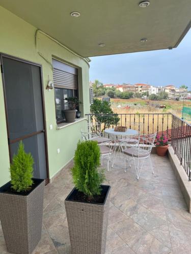 a patio with a table and chairs on a balcony at Ioannis Villa in Nea Fokea