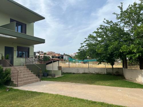 a house with a fence and a yard at Ioannis Villa in Nea Fokea