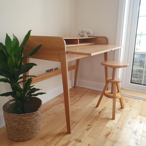 a wooden desk in a room with a plant at Panorama House - 400m from Sandbanks beach in Sandbanks