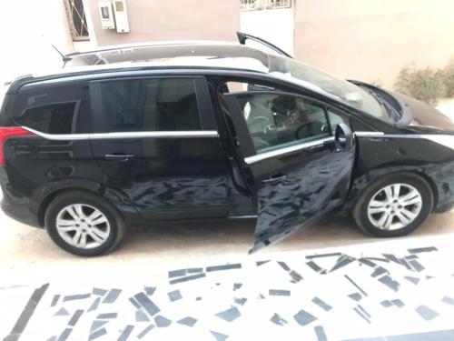 a black car with its door open on a street at Dakar Top destination in Dakar