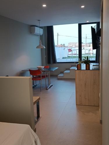 a living room with a table and a dining room at La Cambreta in Pedreguer