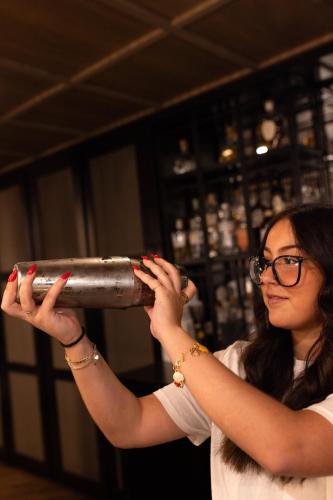 a woman holding a silver cylinder in a room at Holiday Inn St-Jean-sur-Richelieu Congrès by IHG in Saint-Jean-sur-Richelieu