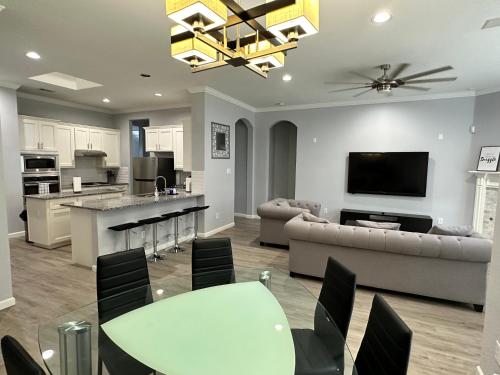 a living room with a couch and a table at New Spacious 5-bedroom Home for Large Family in Garland