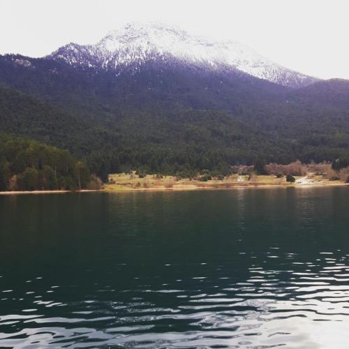 a view of a mountain from a body of water at Feneos apartment in Feneos