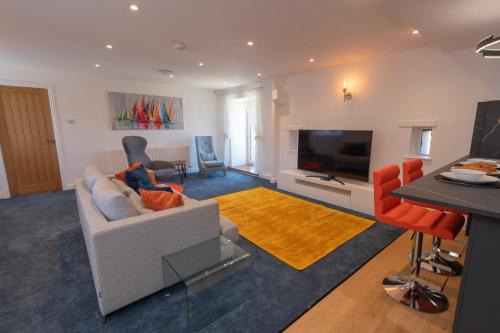 a living room with a couch and a flat screen tv at The Hayloft, Sewerby, Bridlington, Wi-Fi & Parking in Bridlington