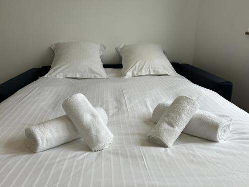a white bed with four four towels on it at Studio Siana in Chartres