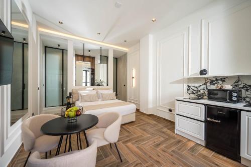 a bedroom with a bed and a table and chairs at Montre Fine Living in Agios Nikolaos