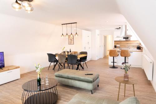 a living room and dining room with a table and chairs at Apartments am Marktplatz in Bad Urach