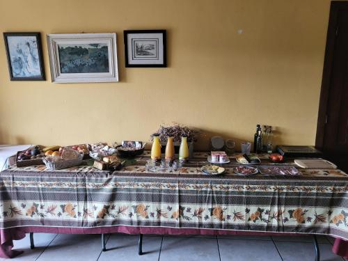 a table with a table cloth with food on it at HOTEL PASTERAL RIU TER in La Cellera de Ter