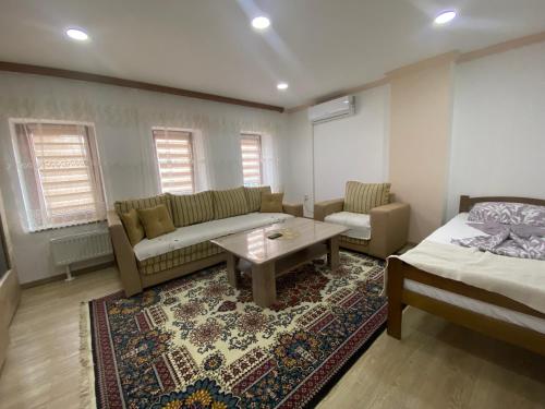 a living room with a couch and a bed and a table at Apartment Poturmahala 2 in Travnik