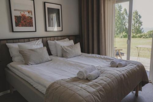 a bedroom with a bed with towels on it at Siljansnäs Hotell in Siljansnäs