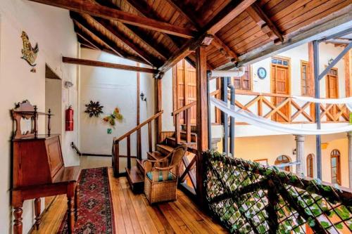 a room with a staircase in a house at Hostal La Suite in Sangolquí