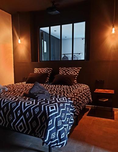 a bedroom with a bed and a window at La Loge in Sinceny
