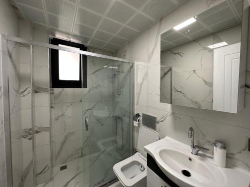 a bathroom with a shower and a sink and a toilet at Dalyan villa star 1 in Ortaca