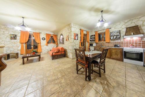 a kitchen and living room with a table and chairs at Parys Villas in Tsilivi