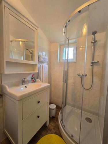 a bathroom with a sink and a shower at Apartments Marija in Vir