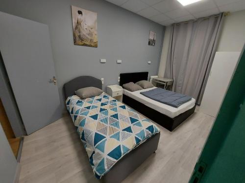 Postel nebo postele na pokoji v ubytování Ardenn'Hotel