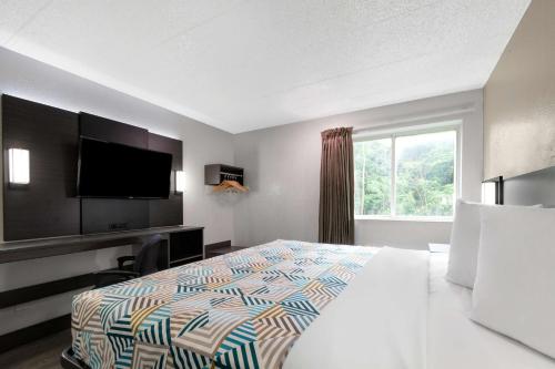 a hotel room with a bed and a television at Motel 6-York, PA - North in York