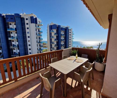 a table and chairs on a balcony with a view of the ocean at PUNTA PRIMA Seaview in Torrevieja
