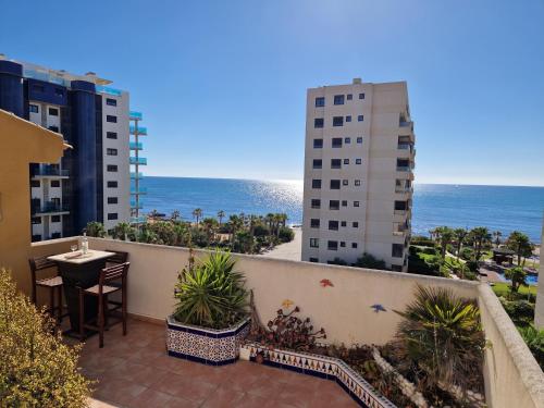 a balcony with a table and a view of the ocean at PUNTA PRIMA Seaview in Torrevieja