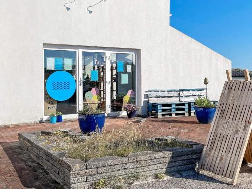 a store with blue vases in front of a building at 6 person holiday home in Brovst-By Traum in Brovst