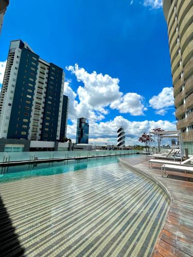 a swimming pool in a city with tall buildings at Hotel Sonata Angelopolis in Lomas de Angelopolis