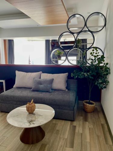 a living room with a couch and a table at Hotel Sonata Angelopolis in Lomas de Angelopolis