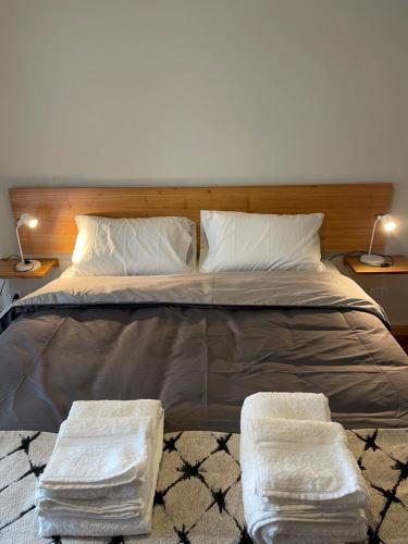 a bedroom with a large bed with two white pillows at Montevideo Suite in Rosario