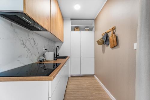a kitchen with white cabinets and a counter top at Luce mobile homes L1, L2, L3 in Drage
