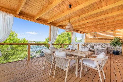 a dining room with a table and chairs on a deck at Luce mobile homes L1, L2, L3 in Drage